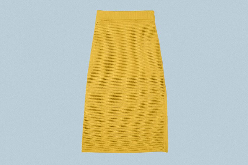 Yellow crochet skirt on grey background