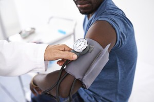 Doctor taking patient's blood pressure