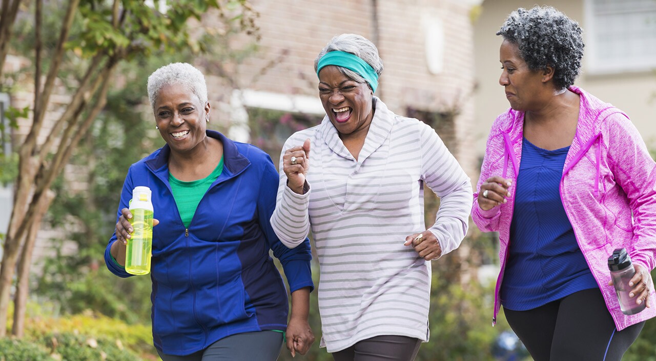 Three senior black women exercising together