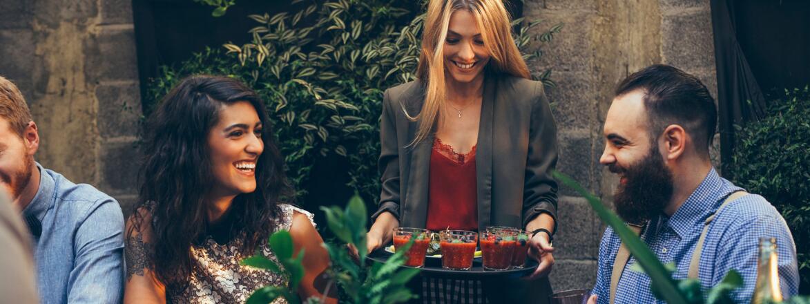 Woman serving a tray of food at party