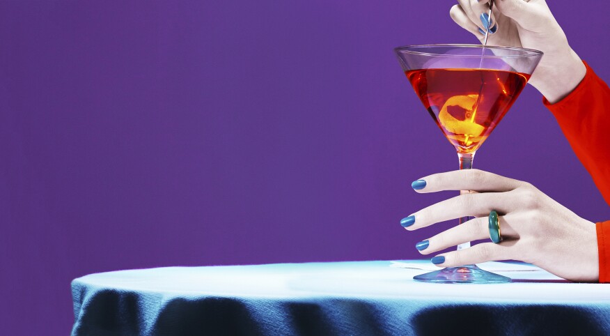 woman's hands holding a martini glass