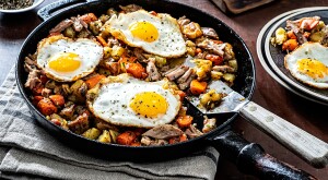 Turkey breakfast skillet with fried eggs in cast iron pan
