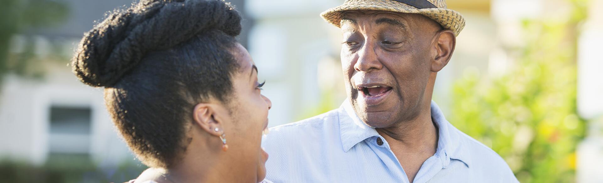 Senior man in front yard with adult daughter