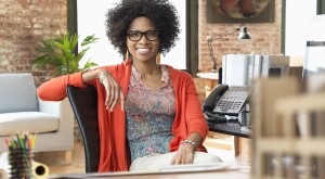 image_of_woman_smiling_sitting_in_office_GettyImages-672159651_1800