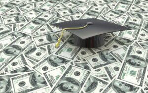 Student loan graphic of graduation cap on hundred dollar bills