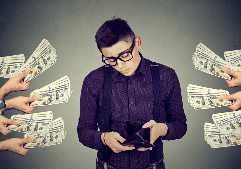 Sad man with empty wallet being offered money dollar banknotes