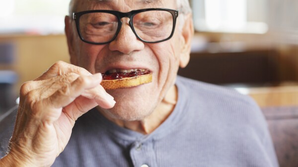Senior Man Eating Toast and Jelly Jam