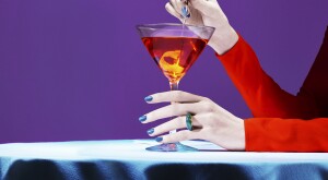 woman's hands holding a martini glass