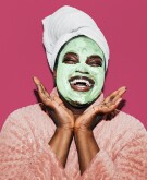 Black woman with facial mask smiling