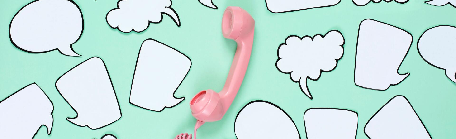 Pink phone used to stay in touch with friends surrounded by speech bubbles.