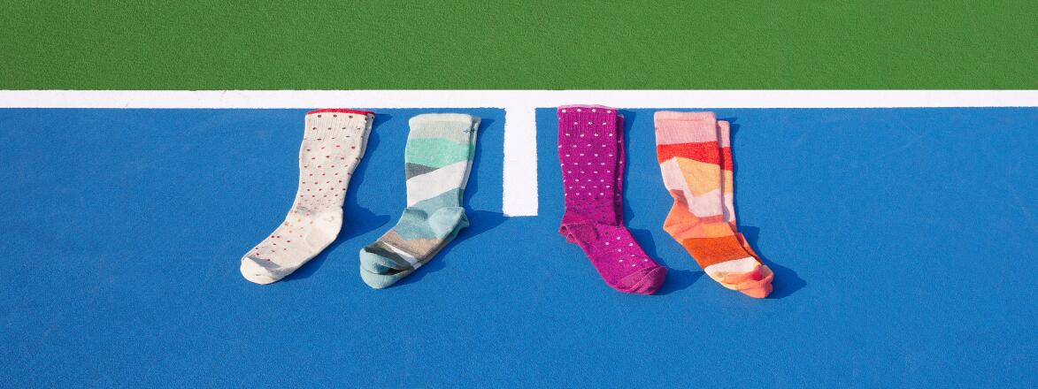 compression socks photographed on a blue tennis court