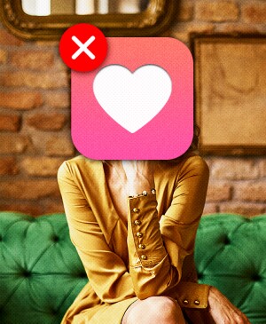 Woman on green sofa with brick wall in background, heart symbol covering face