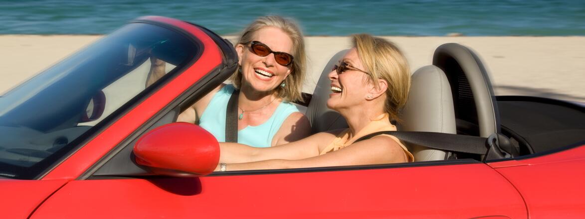 Two women in a red convertible