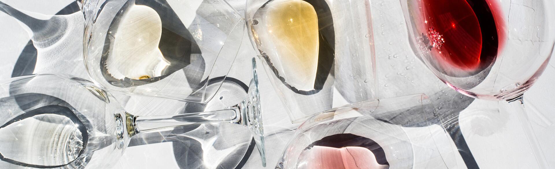 Wine Glasses on a white surface with With Different Types Of Wine inside