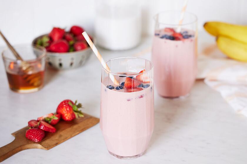 Summer smoothies styled on a white kitchen counter