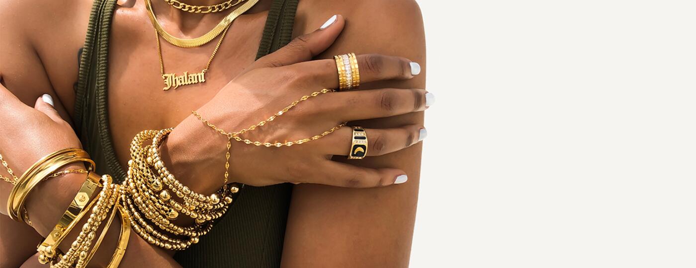 Black woman with layers of gold jewelry