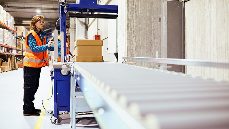 Female works in a factory warehouse.