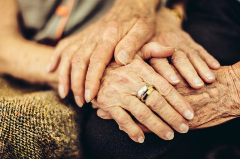 Older people holding hands