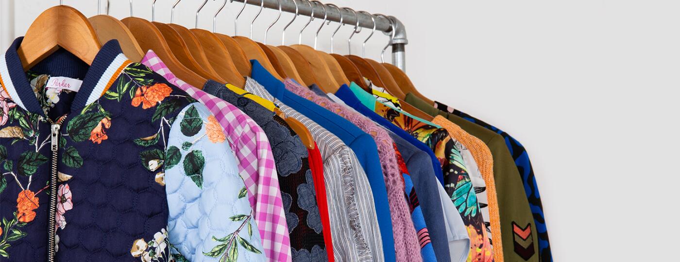 image of clothes on rack by armoire