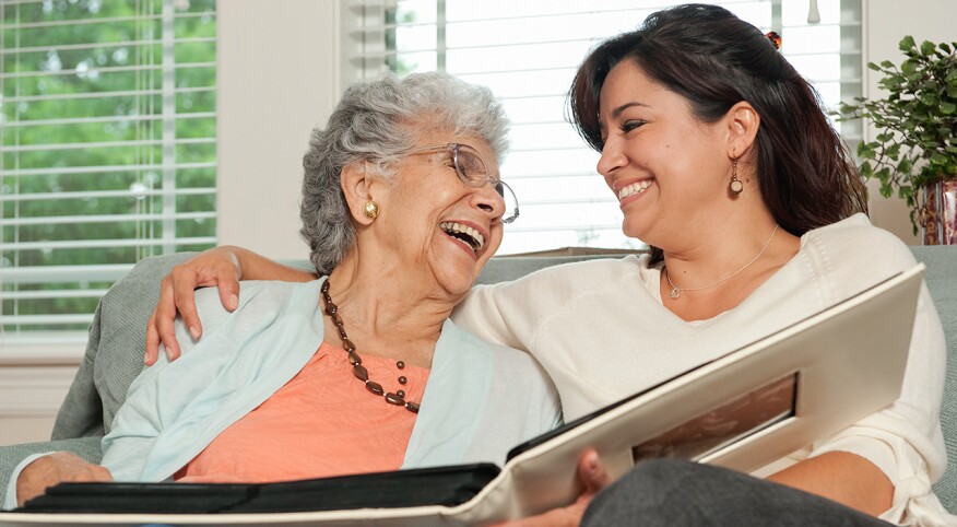 Adult child sharing moment with senior mom