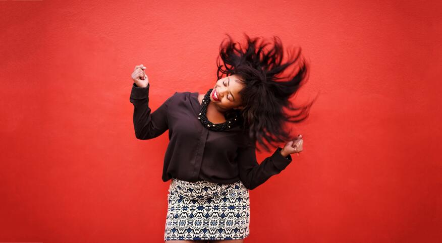 African American Woman Dancing on red background to cheer up