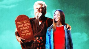 A figure appearing to look like Moses with an arm around a teenage daughter is holding a tablet that states, "Thou Shalt Raise Teens (Without Losing My Mind)