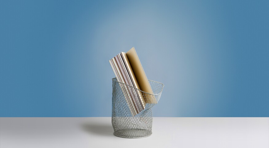 Large book in wastepaper basket