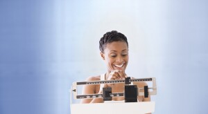image_of_woman_weighing_herself_on_a_scale_GettyImages-77147010v2_1800