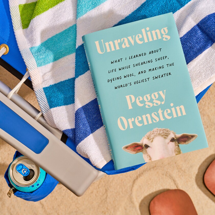 Book styled in the sand with beach accessories