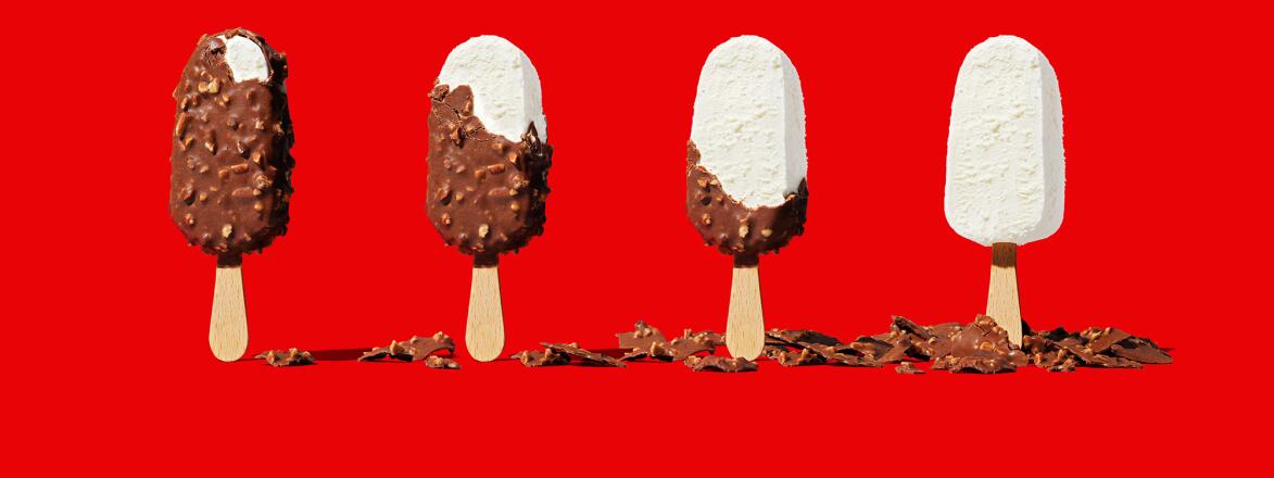 Ice cream bars with chocolate chipped away revealing vanilla ice cream 