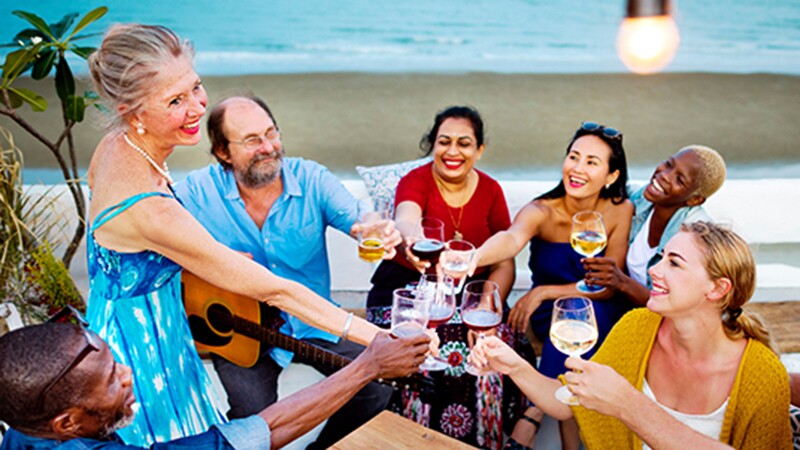 A group of people drinking together on the beach