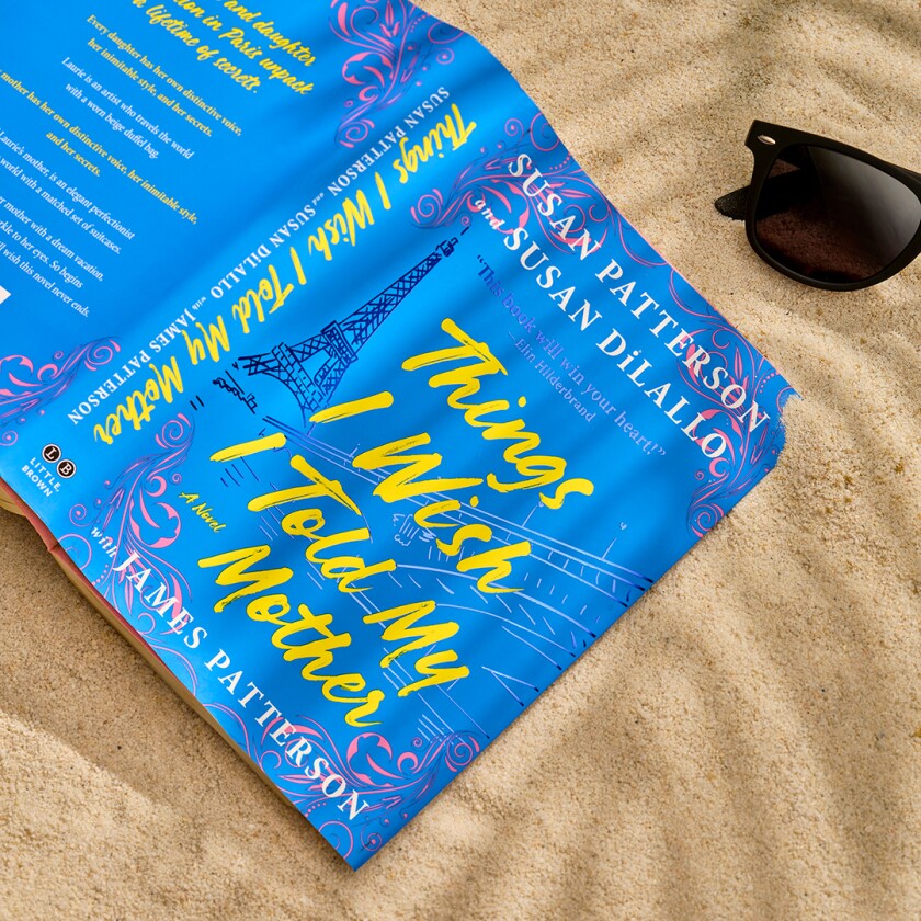 Book styled in the sand with beach accessories