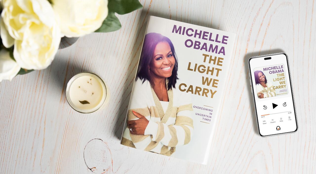 Michelle Obama's Book The Light We Carry on a table with flowers