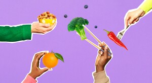 Four hands holding various fruits and vegetables on a purple background
