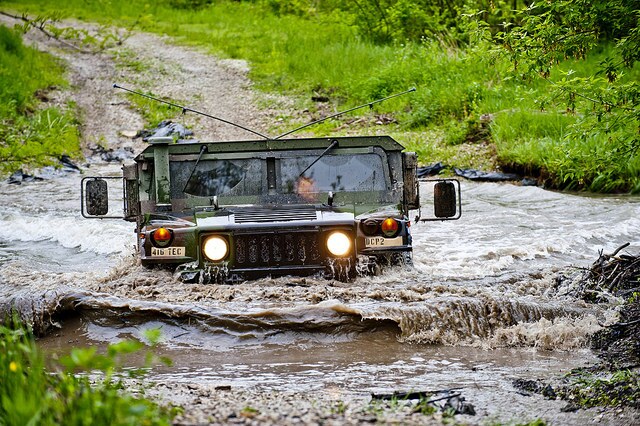 Humvee driving through creek