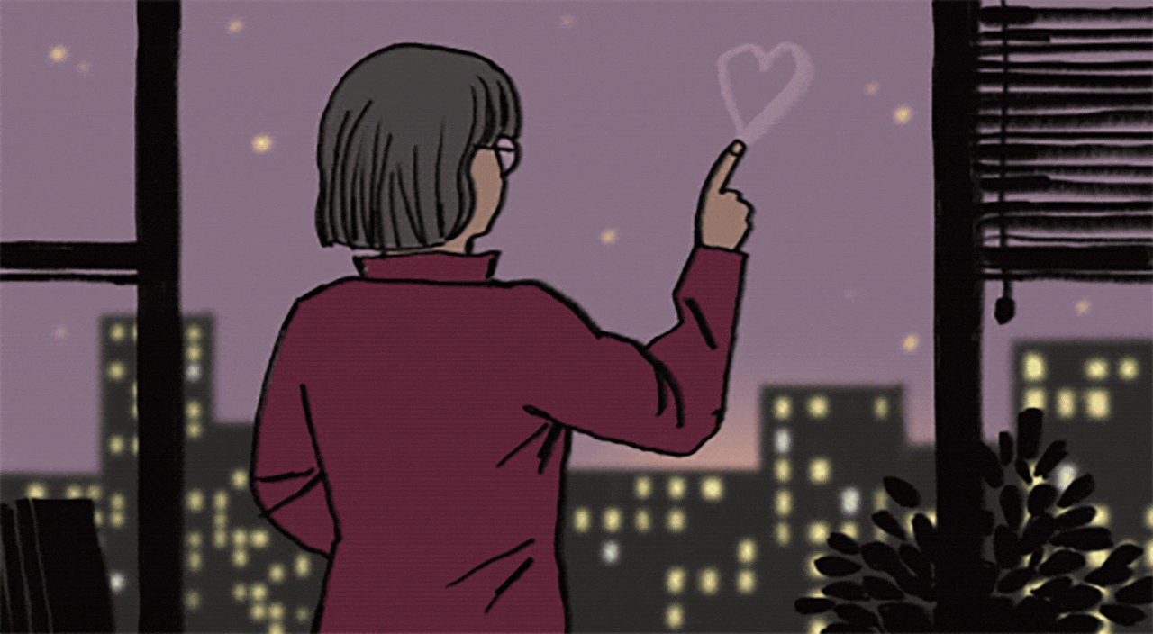 Woman drawing heart on glass window while the sun is rising over the city.