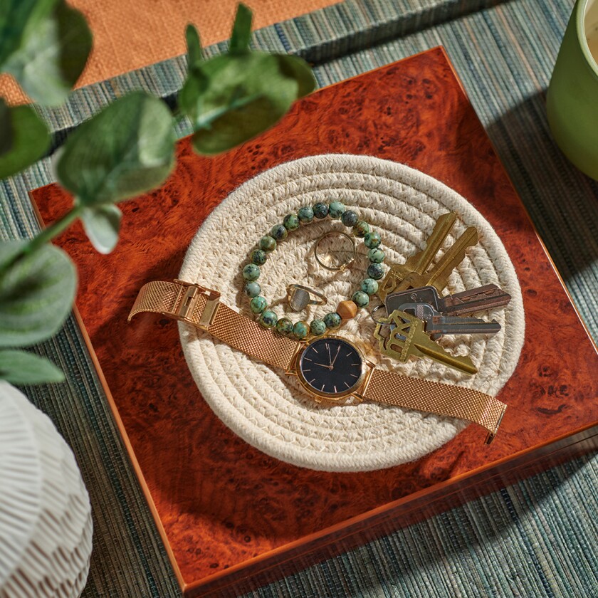 trinket tray holding watch, bracelet and keys