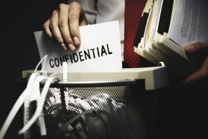 Man shredding confidential documents