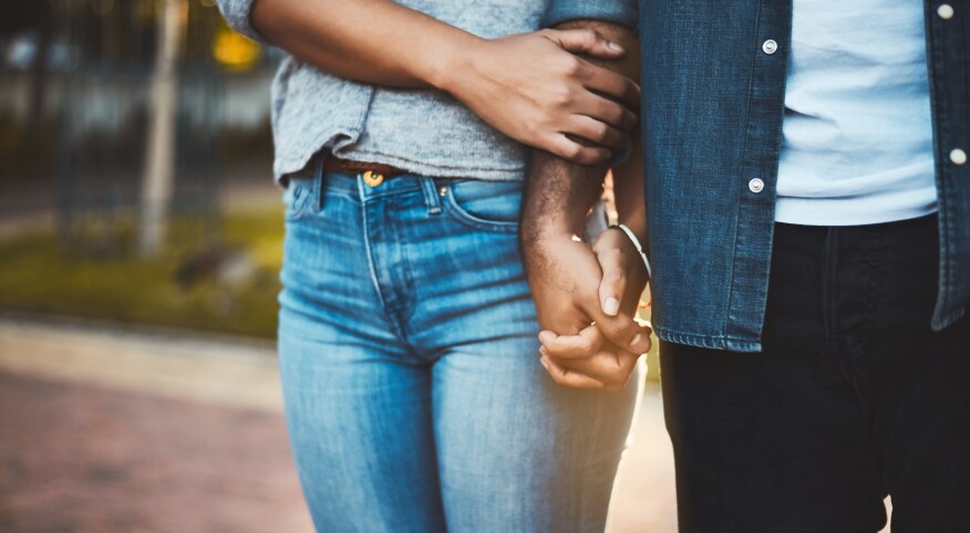 woman and mans hands interlocked