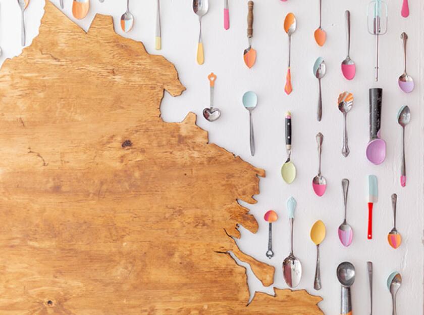 Wall of decorative ice cream scoops and spoons at Ruby Scoops Ice Cream & Sweets in Richmond, VA.