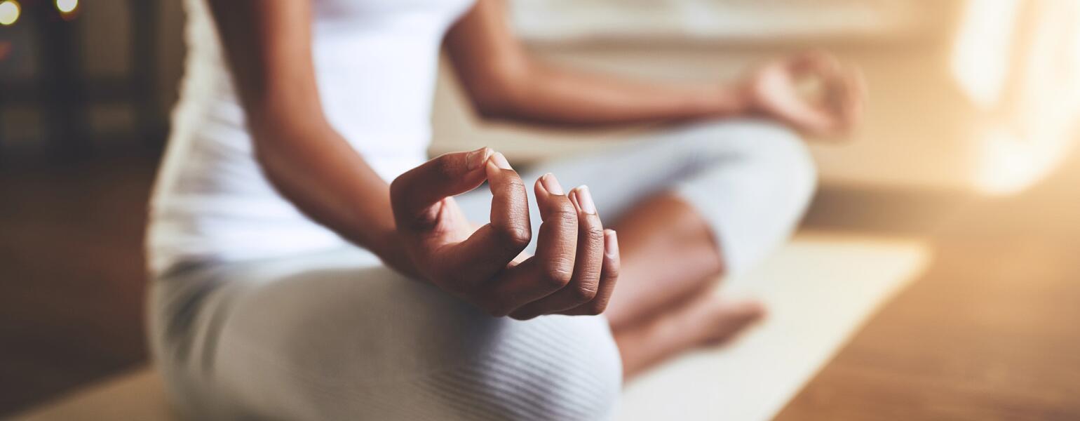 woman practicing guided meditation at home