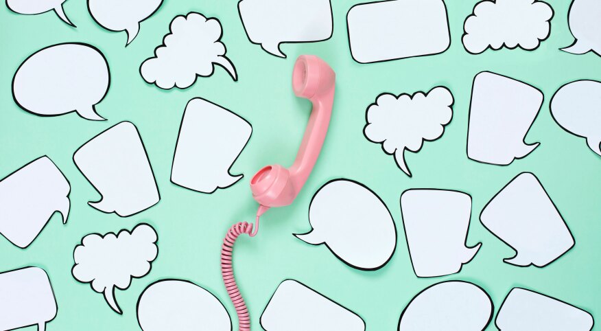 Pink phone used to stay in touch with friends surrounded by speech bubbles.