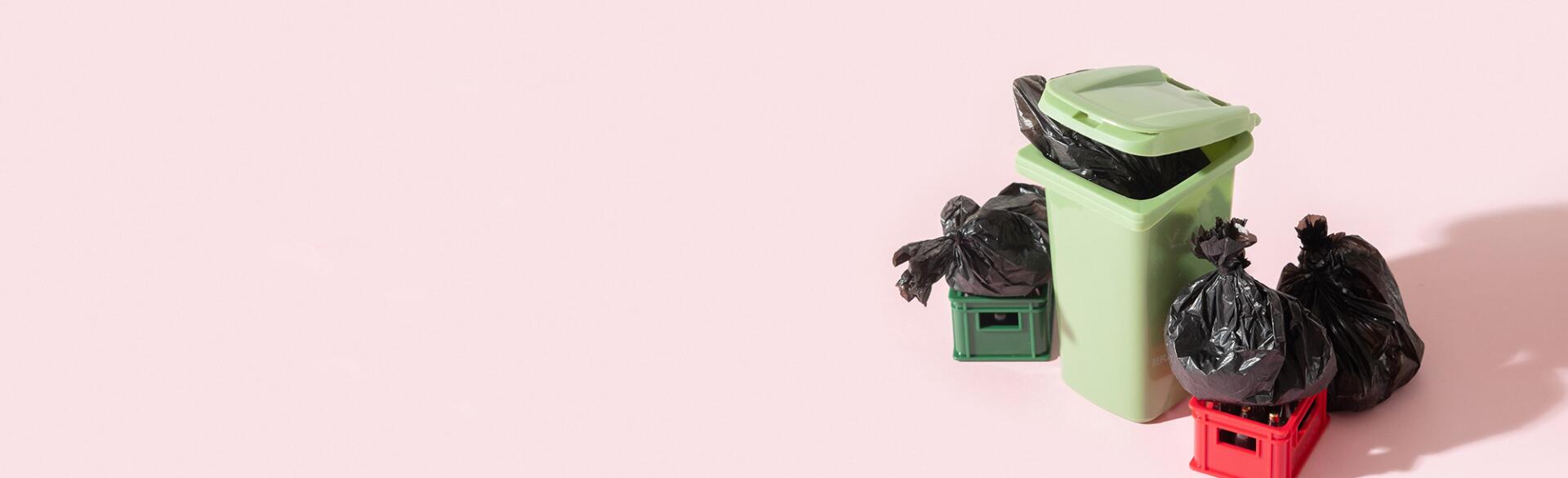 Garbage can, trash and recycling on pink background