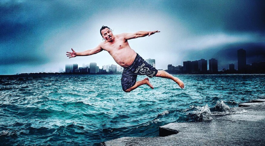 Shirtless man jumping into body of water