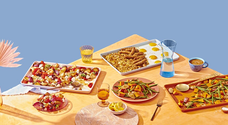 Group shot of three sheet pan recipes on a wood table with blue background