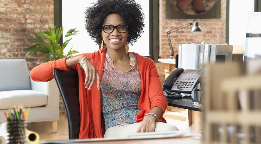 image_of_woman_smiling_sitting_in_office_GettyImages-672159651_1800