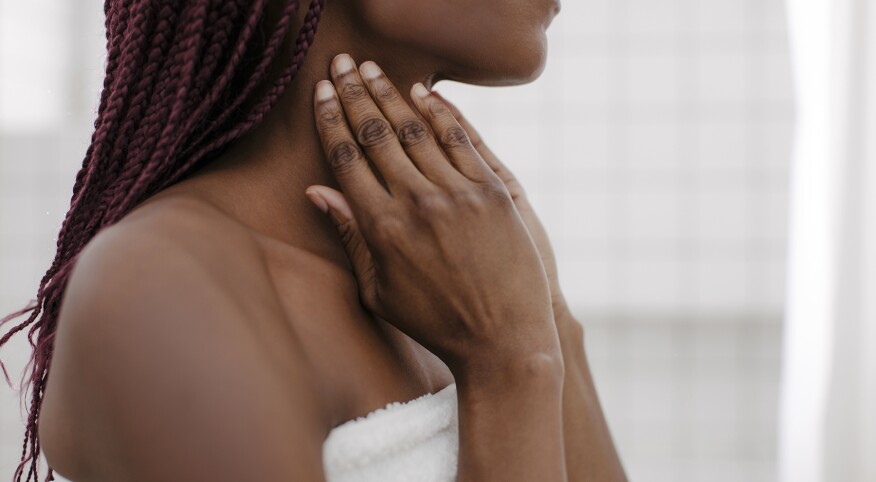 A Woman Touching her Neck