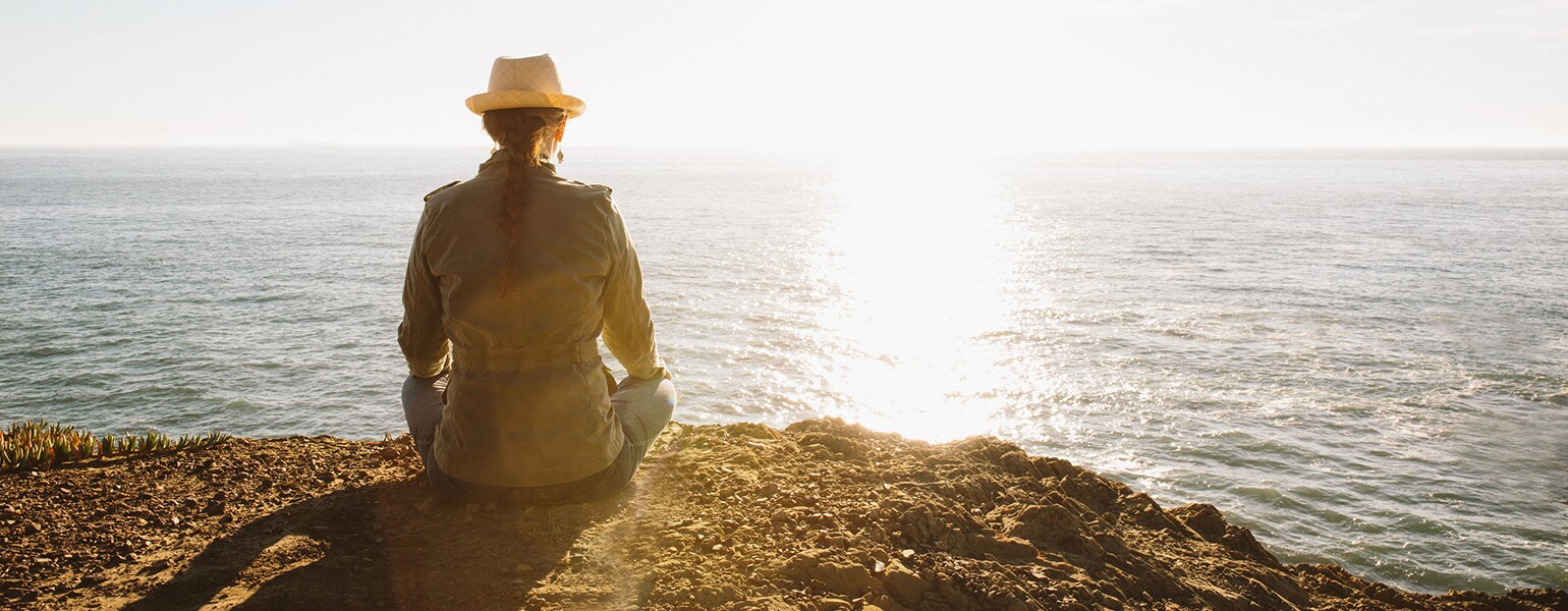 Woman Meditating In Nature By Ocean