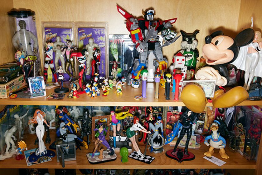 Bookshelf filled with vintage toys and action figure collectibles