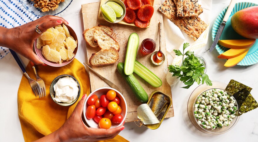 Overhead shot of charcuterie board styled with bright tablewear